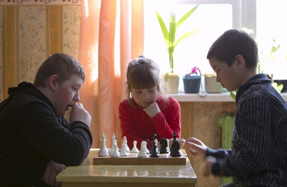 Pupils play chess, as they prepare for the local competitions, at a school based in the remote Russian village of Bolshie Khutora