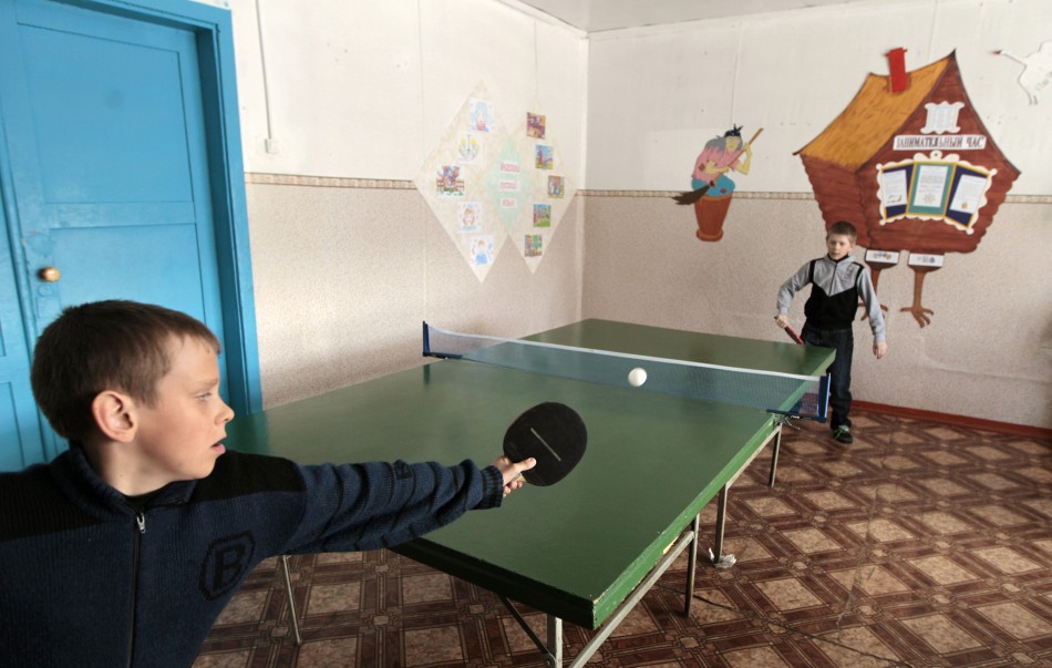 Pupils play table tennis at a local school in the remote Russian village of Bolshie Khutora