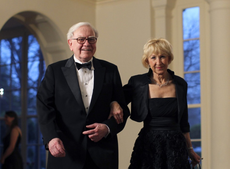 Business magnate Warren Buffett and his wife Astrid Menks arrive for a State Dinner held in honor of Britain's Prime Minister David Cameron and his wife Samantha at the White House in Washington March 14, 2012.