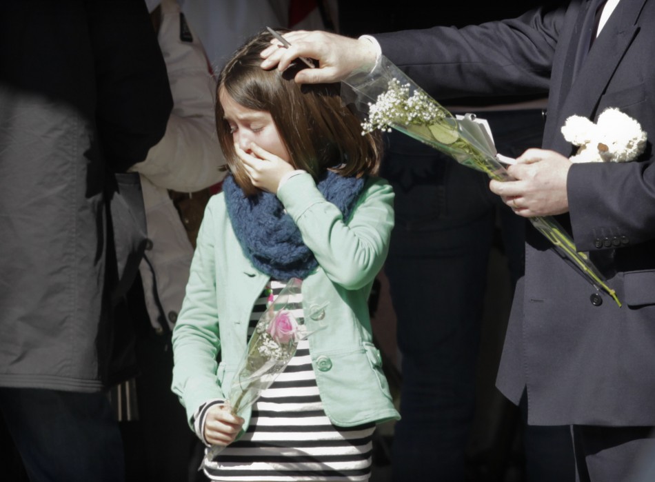 Relatives of the victims of a bus crash in Sierre stand outside their hotel in Uvrier near Sion