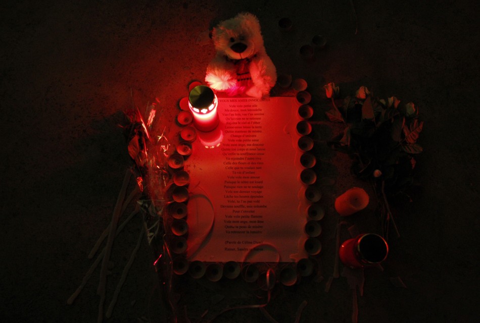 A lit candle and a teddy bear are seen next to the lyrics of singer Celine Dions song quotVolequot to pay tribute to the victims of Sierres bus crash at the Lac de Geronde outside Sierre A lit candle and a teddy bear are seen next to the lyrics of