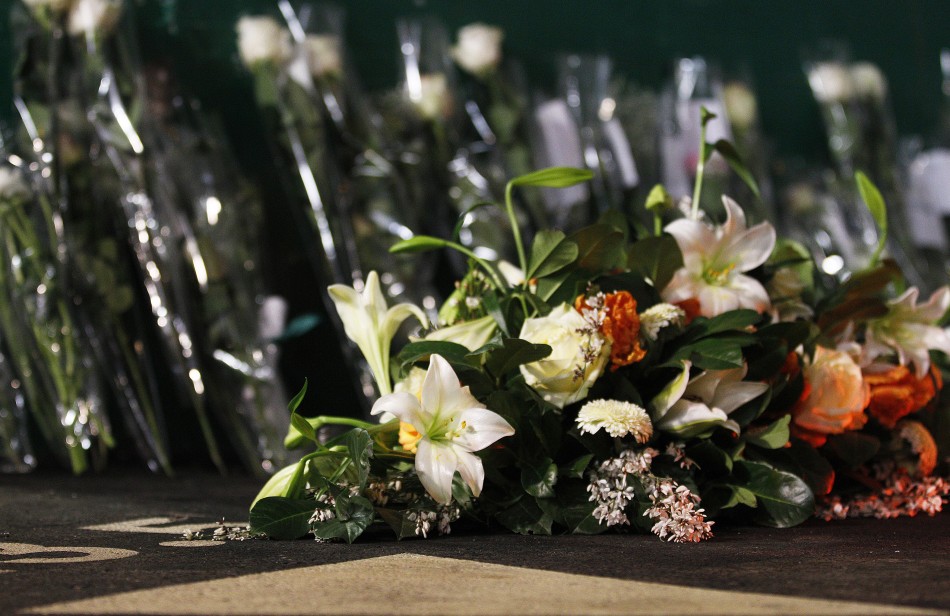 Flowers are placed at scene of an accident inside Tunnel de Sierre, during a news conference in Sierre