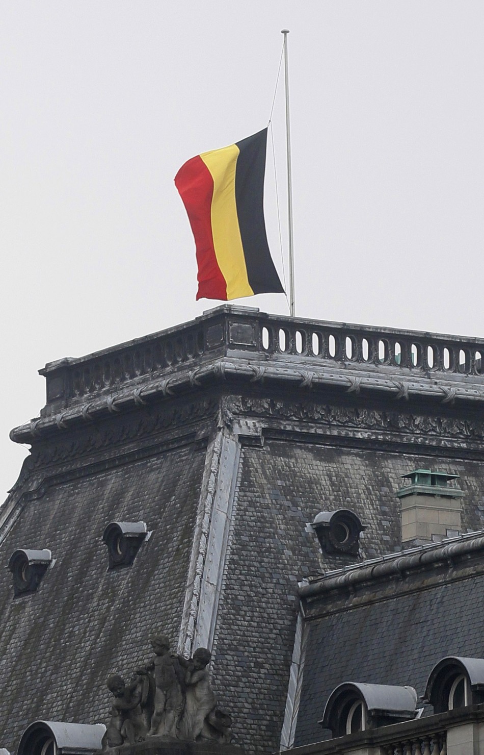 A Belgian flag flies at half mast outside the Belgian Royal Palace in Brussels
