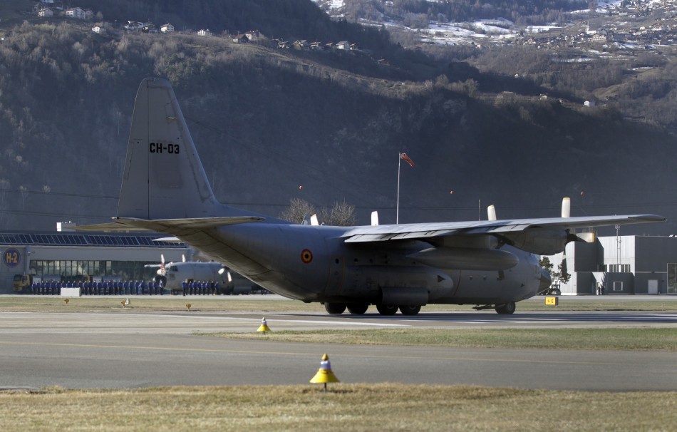 A Belgian army Hercules aircraft carrying an unknown number of bodies gets ready to take off at the airport in Sion