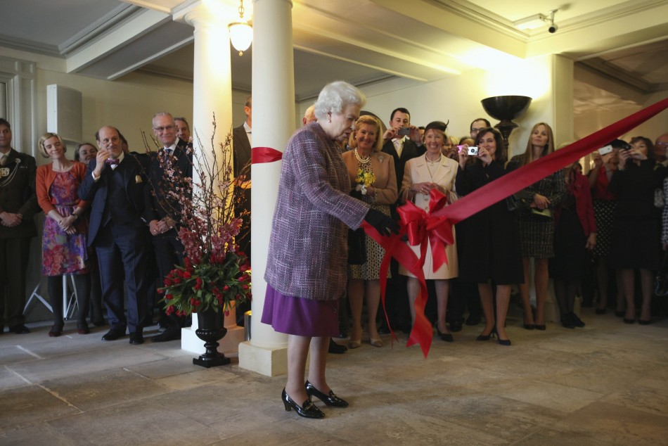 Britain039s Queen Elizabeth pulls the ribbon during the official reopening of Kensington Palace in London