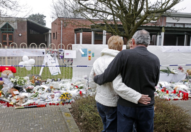 Neighbours and relatives of victims of a bus crash in Switzerland react after observing a minute of silence in front of the Stekske school in Lommel (Reuters)