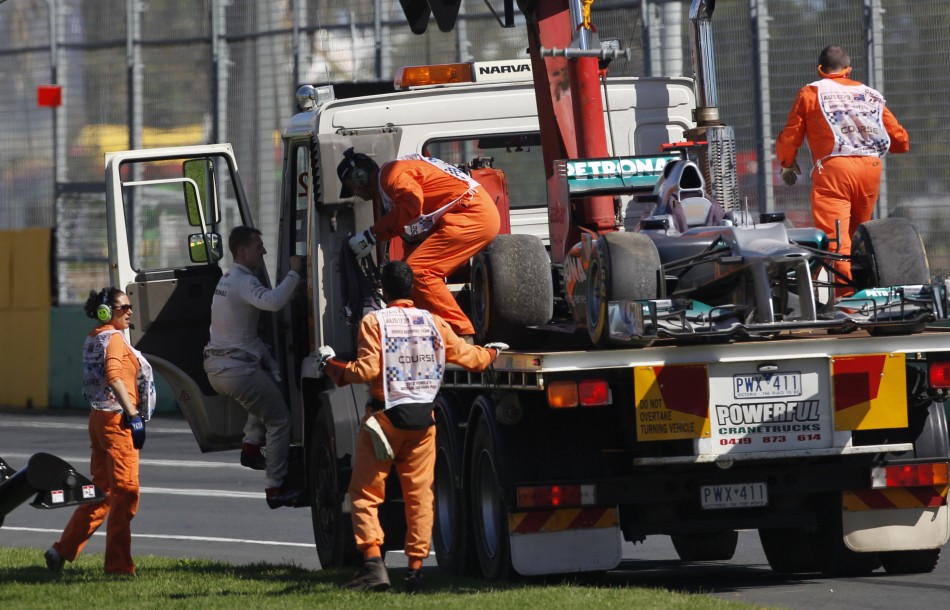Mercedes Schumacher climbs into the cab of a flatbed recovery truck carrying his car during the third practice session of the Australian F1 Grand Prix at the Albert Park circuit in Melbourne