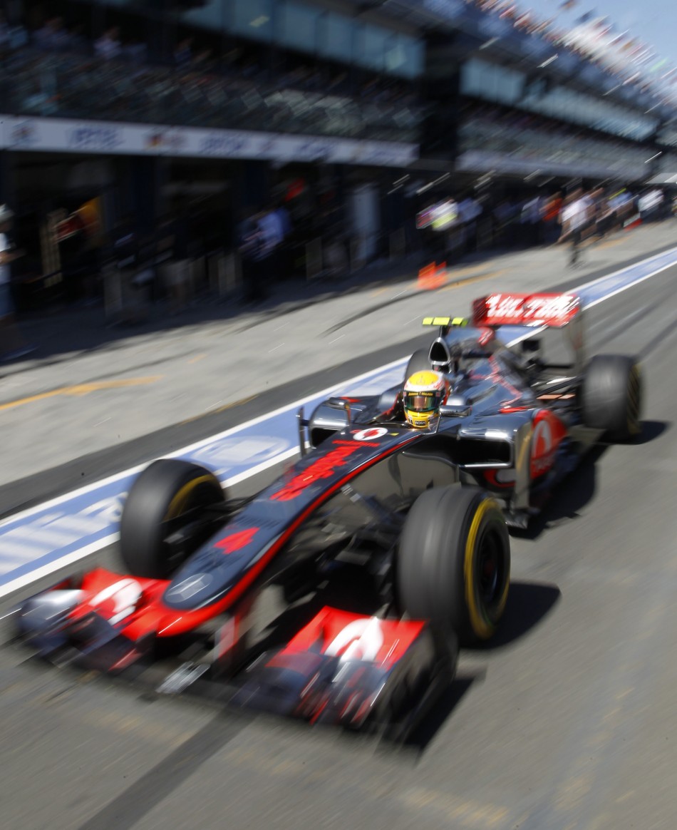 McLaren Formula One driver Hamilton drives in the pit lane during the third practice session of the Australian F1 Grand Prix at the Albert Park circuit in Melbourne