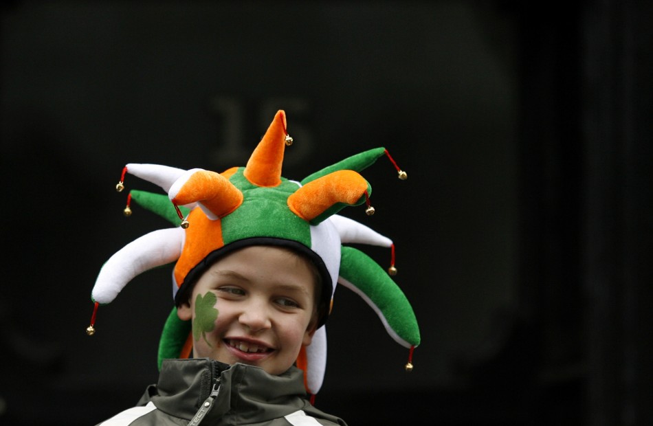 A boy wearing a hat in Irish national colours smiles during the Saint Patricks Day parade along Dublins city centre