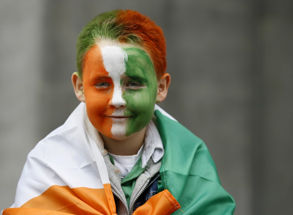 A boy, with his face painted in Irish national colours, smiles during the Saint Patricks Day parade along Dublins city centre