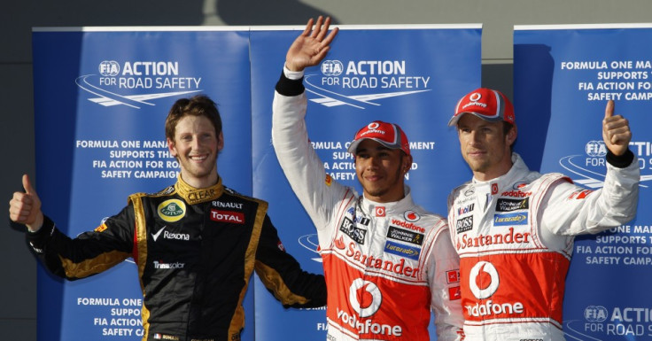 Third classified, Lotus' Grosjean, pole position McLaren's Hamilton and team mate Button wave after the qualifying session of the Australian F1 Grand Prix at the Albert Park circuit in Melbourne