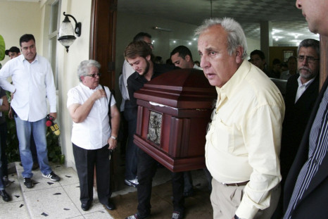 Fernando Berendique, Head of Mission at the Chilean Consulate in Maracaibo, carries the coffin of his 19-year-old daughter Karen, in Maracaibo