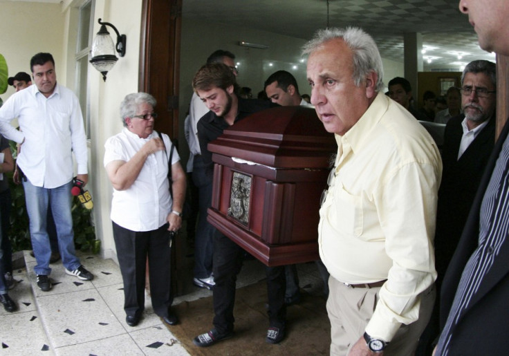 Fernando Berendique, Head of Mission at the Chilean Consulate in Maracaibo, carries the coffin of his 19-year-old daughter Karen, in Maracaibo