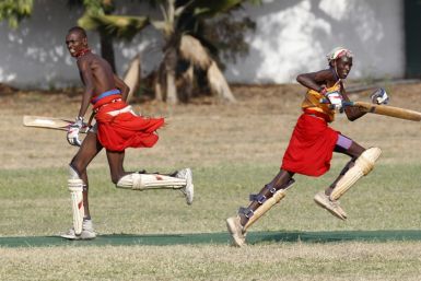 Players from the Maasai Cricket Warriors run between the wicket during their friendly match in Mombasa