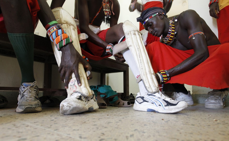 Sonyanga Ole Ngais, captain of the Maasai Cricket Warriors, assists his teammates to dress-up before their friendly match against the Jafferys team in the Kenyan coastal city of Mombasa