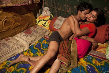 Seventeen-year-old prostitute Hashi, embraces a Babu, her &quot;husband&quot;, inside her small room at Kandapara brothel in Tangail, a northeastern city of Bangladesh