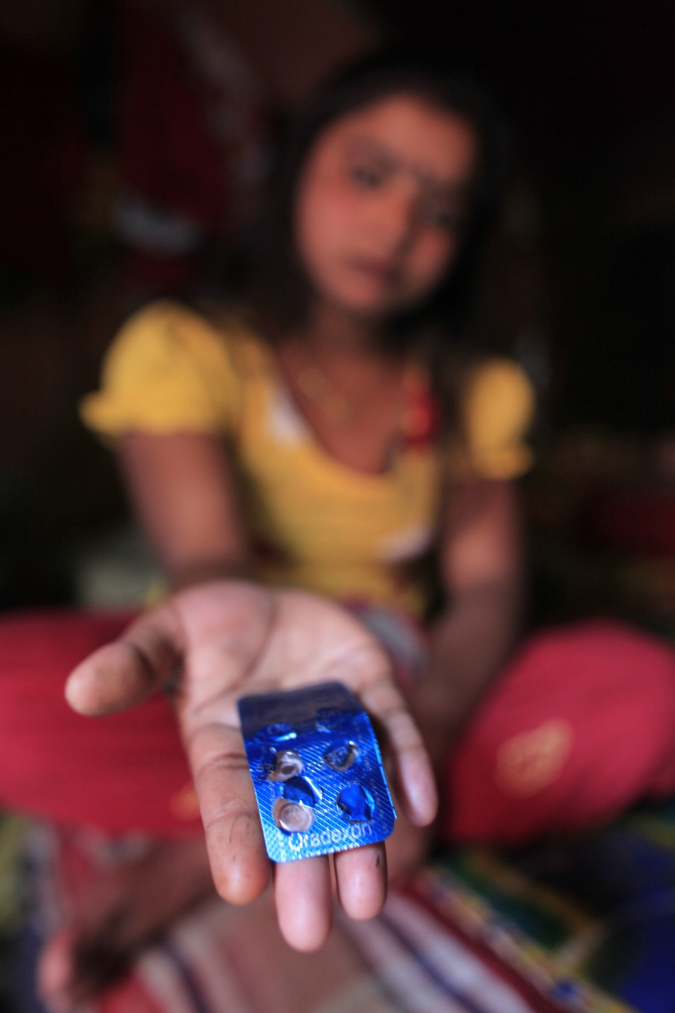 Seventeen-year-old prostitute Hashi shows Oradexon, a steroid, at Kandapara brothel in Tangail, a northeastern city of Bangladesh