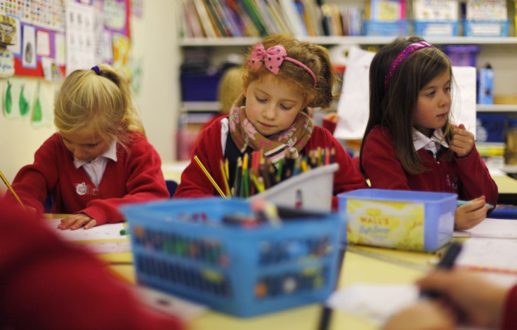 Pupils Freya Sloane, Maddie Malloy, and Isabelle Sloane, concentrate on their drawings at Watlington Primary School in Watlington, southern England