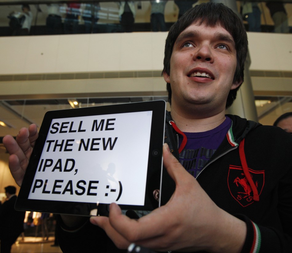 Omarov holds up his iPad at an Apple store in Hong Kong