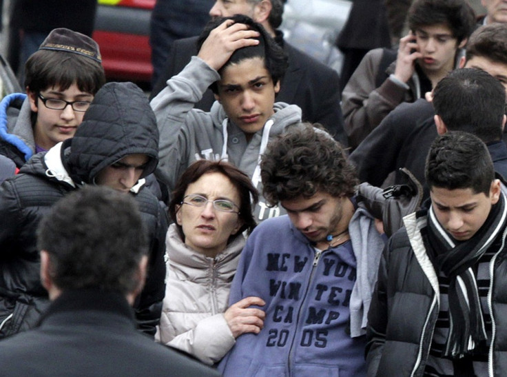 Relatives and school children leave the Ozar Hatorah Jewish school in Toulouse, southwestern France