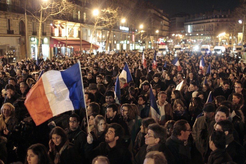 People hold French flags