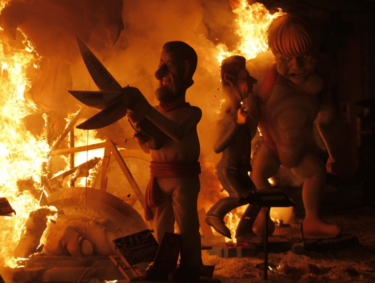 Effigies of Spain's Prime Minister Rajoy and German Chancellor Merkel burn during the finale of the Fallas festival in Valencia
