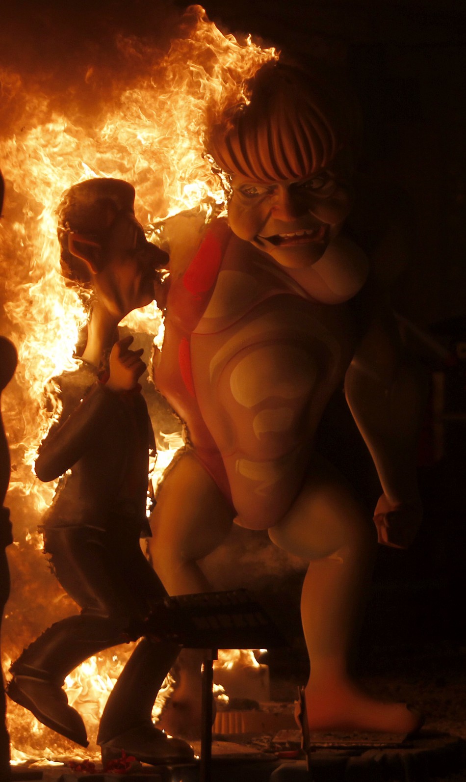 An effigy of German Chancellor Angela Merkel burns during the finale of the Fallas festival in Valencia