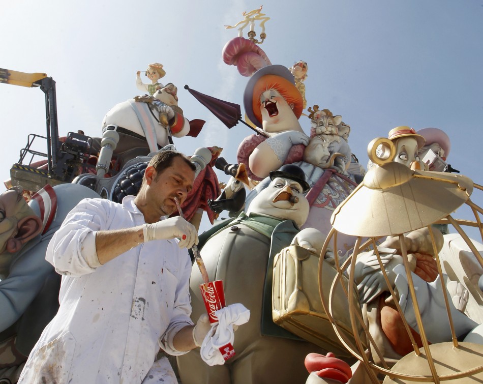 A craftsman puts finishing touches on a giant figure ahead of the quotFallasquot festival in Valencia