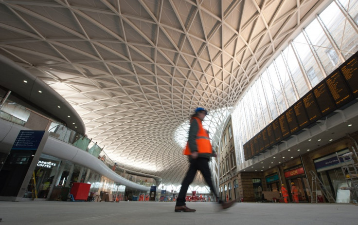 A worker walks in the new Kings Cross rail station redevelopment in London