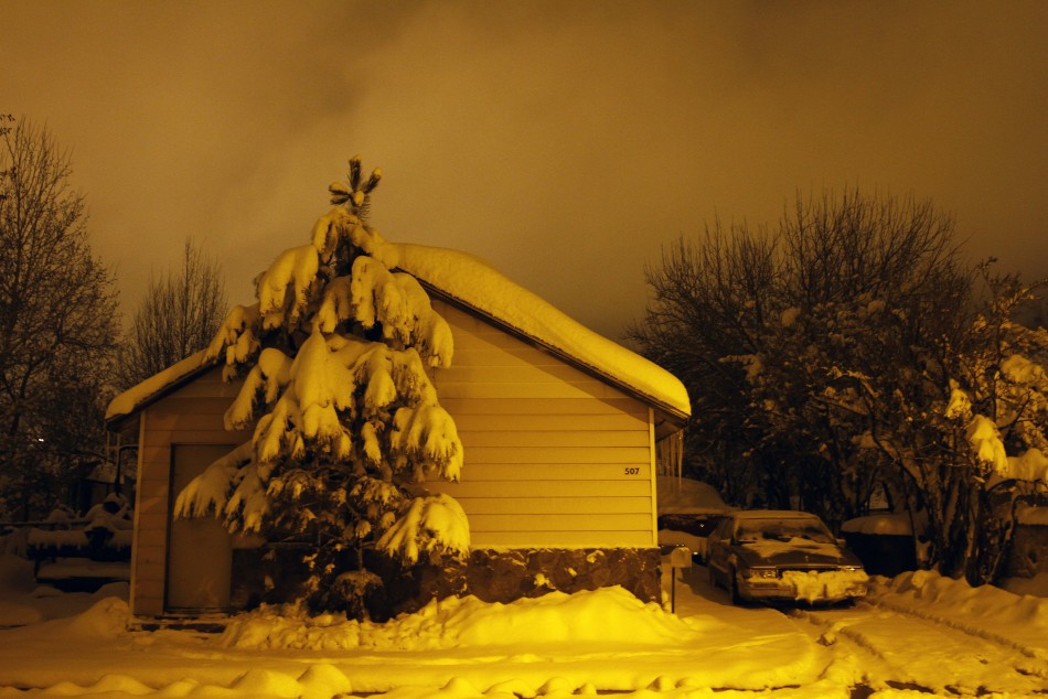 Several inches of snow cover a house and its surroundings in Flagstaff