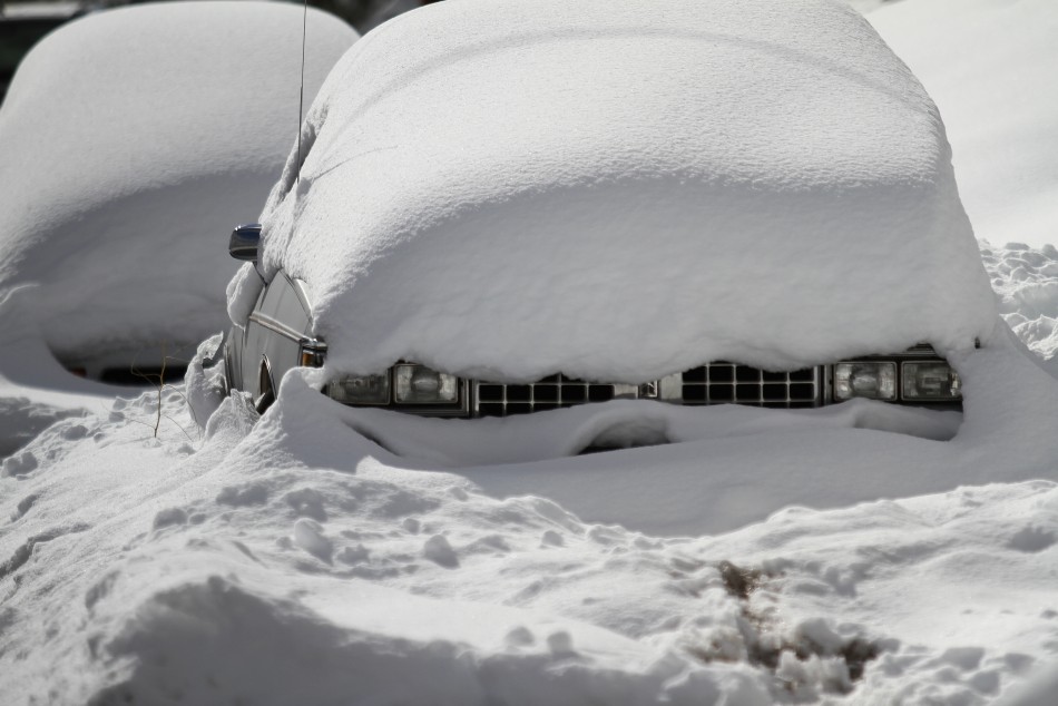 Snow blankets two cars after a winter storm in Flagstaff