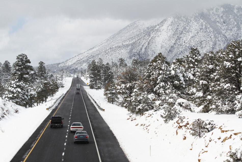 Motorists travel westbound along Interstate 40 after several inches of snow fell during a winter storm in Flagstaff, Arizona