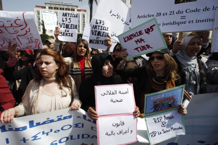 Activists from various women's rights associations gather while holding placards as they protest against the suicide of