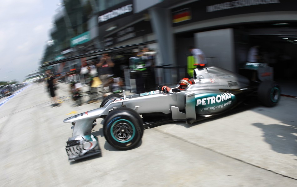 Mercedes Formula One driver Schumacher leaves his teams garage during the first practice session of the Malaysian F1 Grand Prix at Sepang International Circuit outside Kuala Lumpur