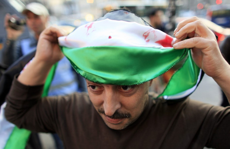 A Syrian protester gets ready to join the anti regime procession in Syria