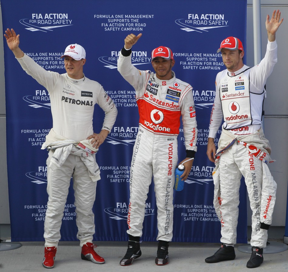 Mercedes039 Schumacher, McLaren039s Hamilton and Button wave after the qualifying session of the Malaysian F1 Grand Prix at Sepang International Circuit outside Kuala Lumpur