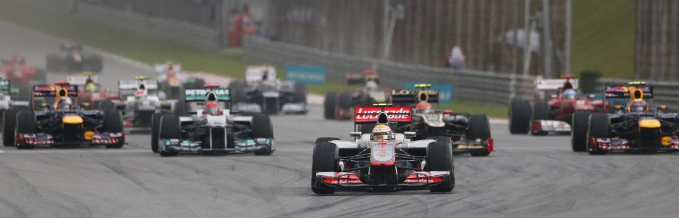 McLaren Formula One driver Hamilton leads the pack on the first corner during the Malaysian F1 Grand Prix at Sepang International Circuit