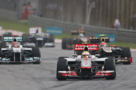 McLaren Formula One driver Hamilton leads the pack on the first corner during the Malaysian F1 Grand Prix at Sepang International Circuit