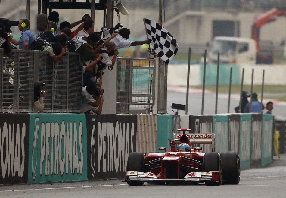 Ferrari Formula One driver Alonso takes the checkered flag to win the Malaysian F1 Grand Prix at Sepang International Circuit outside Kuala Lumpur
