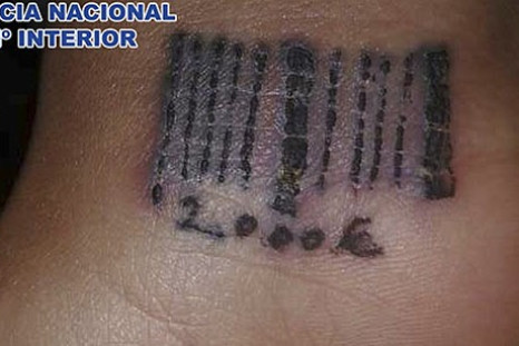 Spanish police free 19-year-old woman who had been beaten, held against her will and tattooed with bar code on wrist