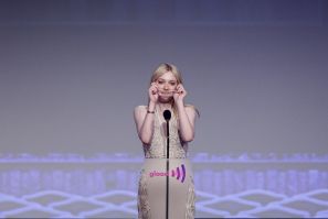 Actress Fanning puts on glasses before speaking at the 23rd annual GLAAD Media Awards in New York