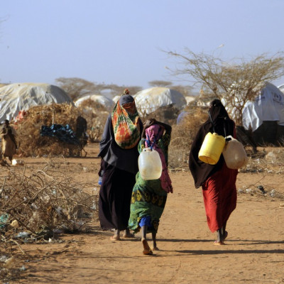 Malian women fetch water from communal tap in Kenya's Dadaab refugee camp