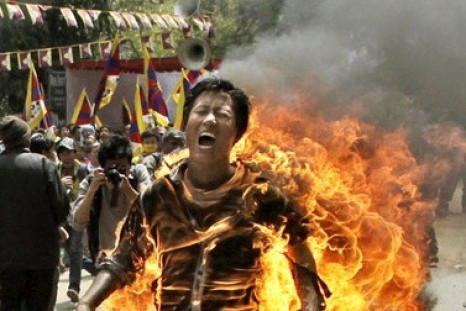 Tibetan activist and exile Jamphel Yeshi, 27, runs through the streets on fire