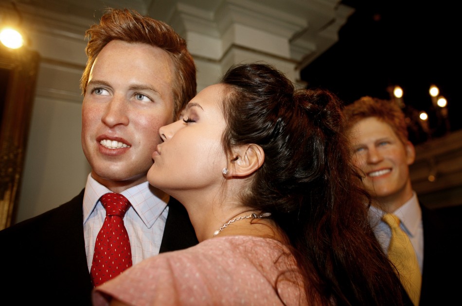 An actress kisses a wax figure of Britains Prince William