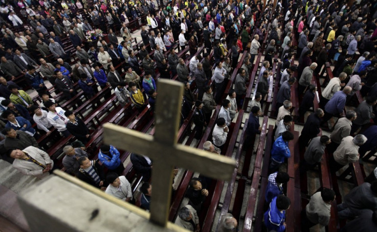 Worshippers pray during a mass at the Liuhe Catholic Church on the outskirts of Qingxu county