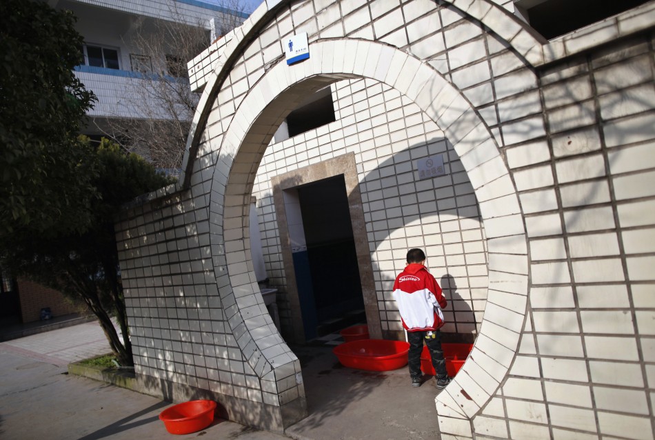 A boy urinates into a container at a primary school in Dongyang