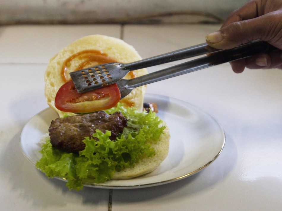 A chef prepares a cobra meat burger at a Chinese restaurant in the ancient city of Yogyakarta
