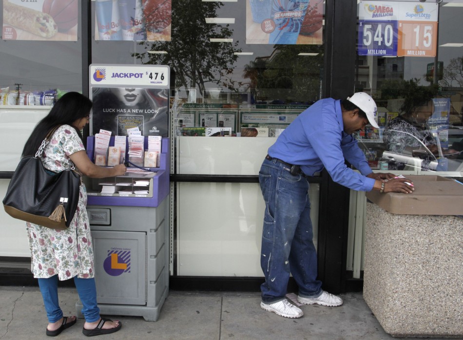 Thompson and Delgado fill out Mega Millions lottery slips for Fridays drawing that has surpassed a jackpot of over 540 million, in Lawndale, California