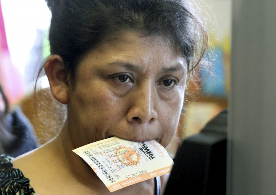 A woman holds a Mega Millions lottery ticket in her mouth in Lawndale