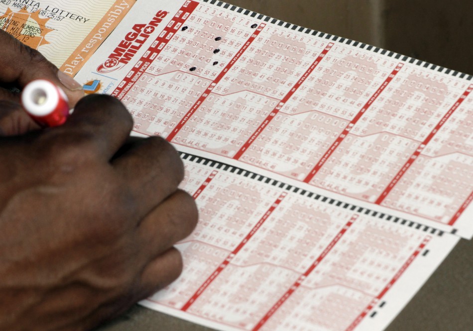 Francisco Delgado fills out a Mega Millions lottery slip for Fridays drawing that has surpassed a jackpot of over 540 million, in Lawndale, California